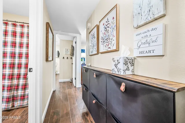 a view of a hallway with paintings on the wall