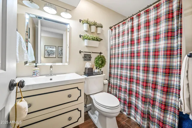 a bathroom with a sink toilet mirror