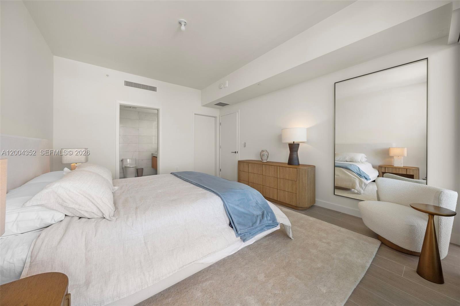 500 Alton Road, Unit 1707 Miami Beach, FL 33139 - Photo 34 of 52 a bedroom with a bed and a mirror