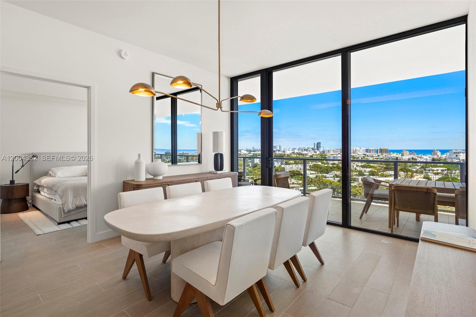 500 Alton Road, Unit 1707 Miami Beach, FL 33139 - Photo 38 of 52 a dining room with furniture and a floor to ceiling window
