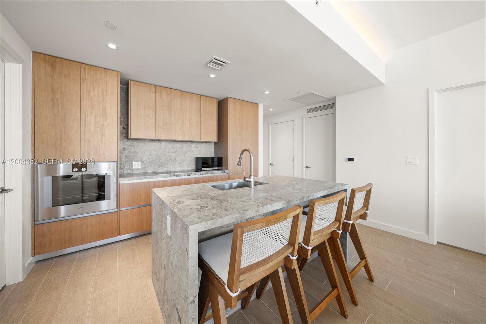 500 Alton Road, Unit 1707 Miami Beach, FL 33139 - Photo 6 of 52 a kitchen with stainless steel appliances granite countertop a kitchen island a stove a sink and a refrigerator