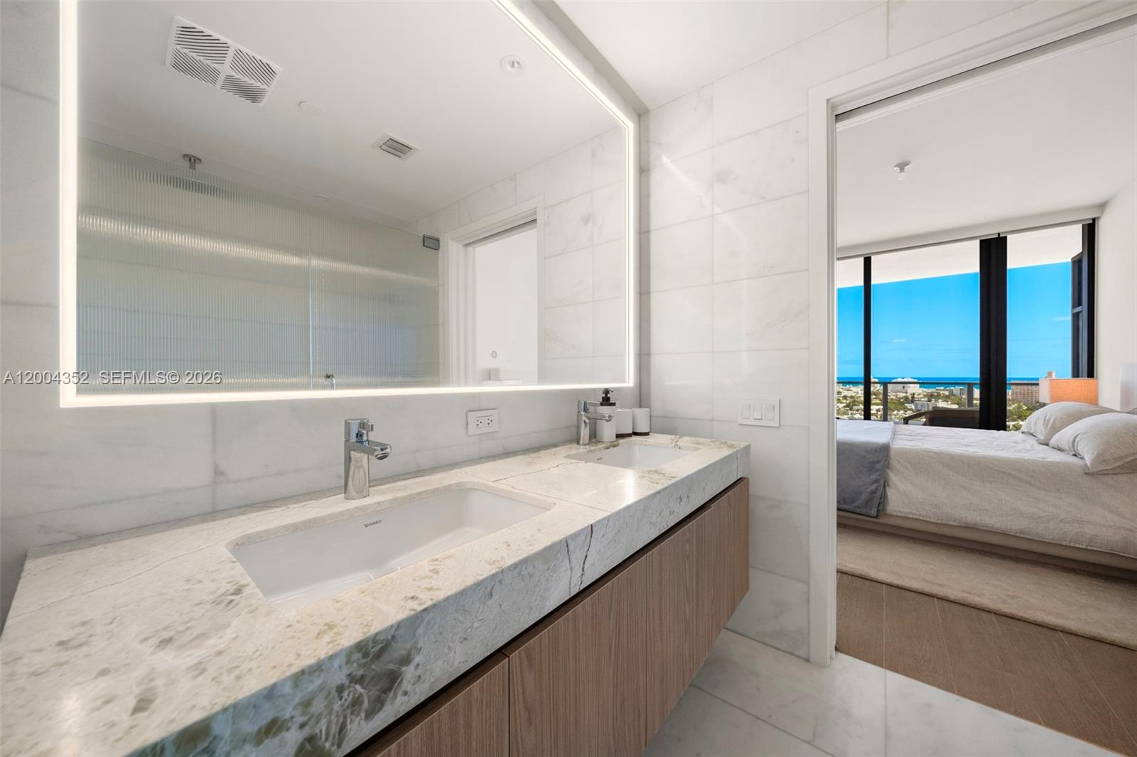 500 Alton Road, Unit 1707 Miami Beach, FL 33139 - Photo 8 of 52 a bathroom with a granite countertop double vanity sink and a mirror