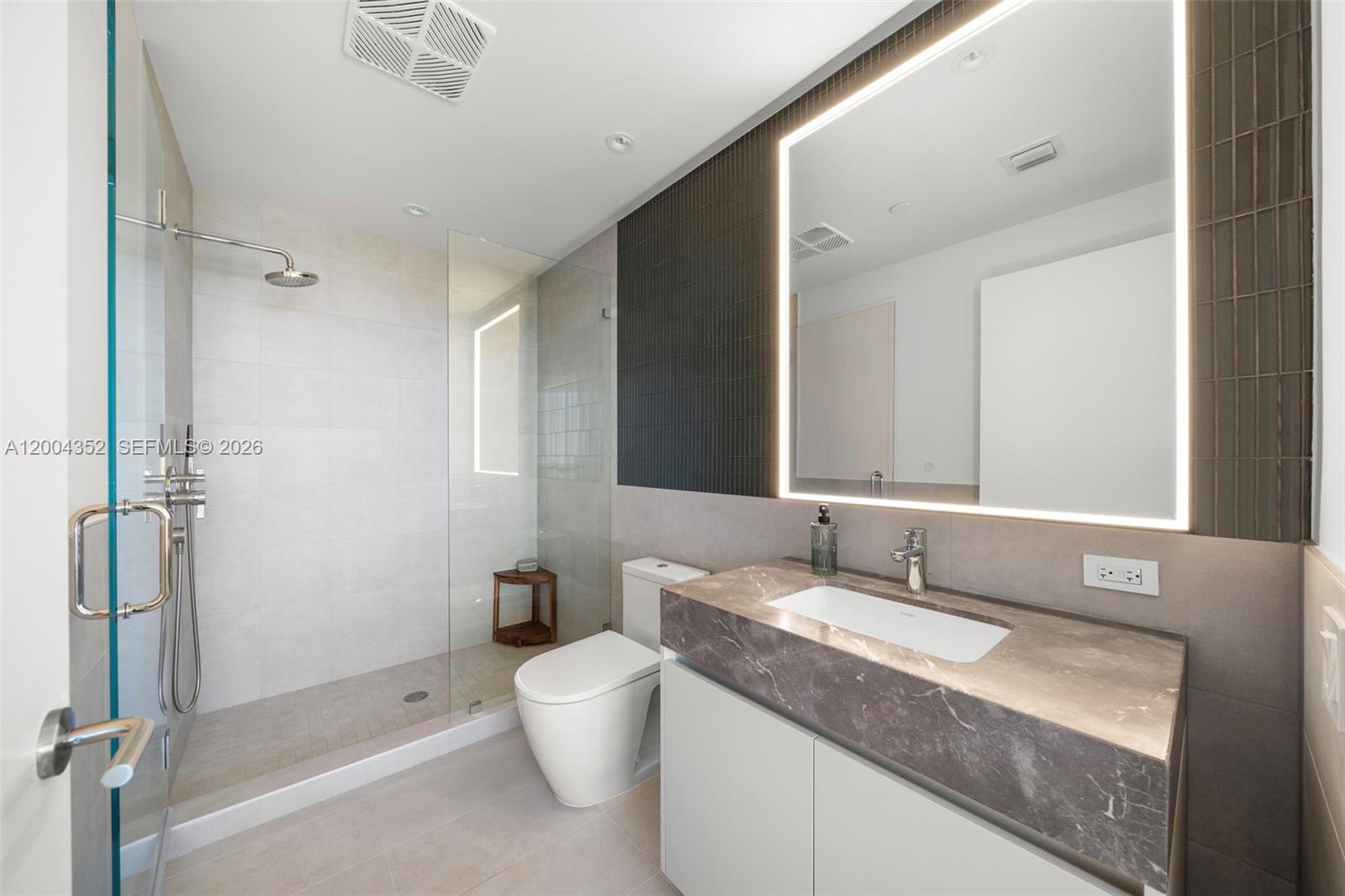500 Alton Road, Unit 1707 Miami Beach, FL 33139 - Photo 10 of 52 a bathroom with a granite countertop sink toilet and shower