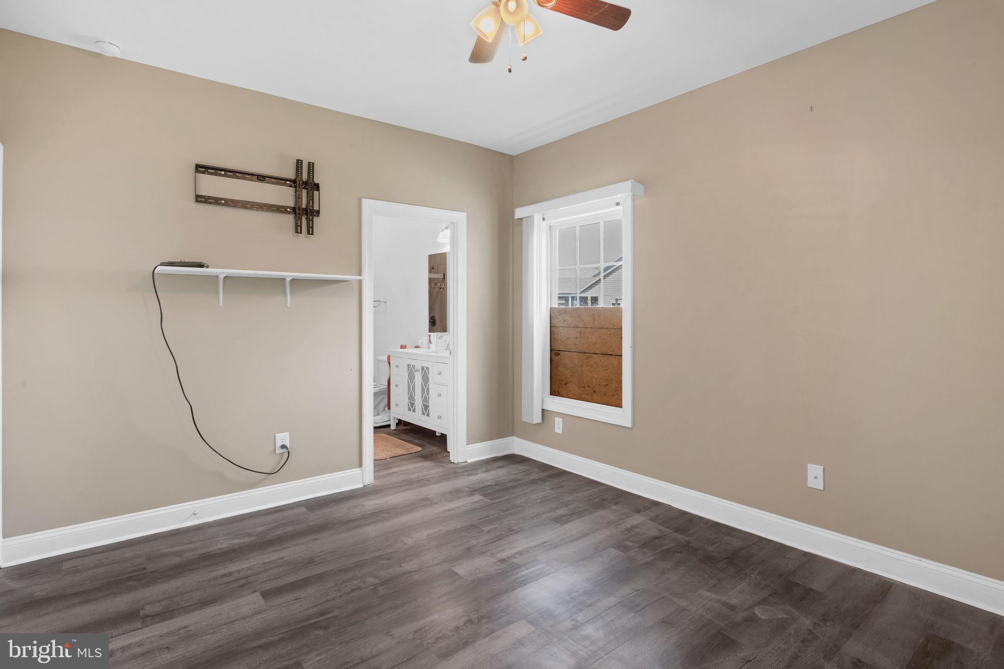 27407 Walking Run Milton, DE 19968 - Photo 15 of 25 an empty room with wooden floor and windows