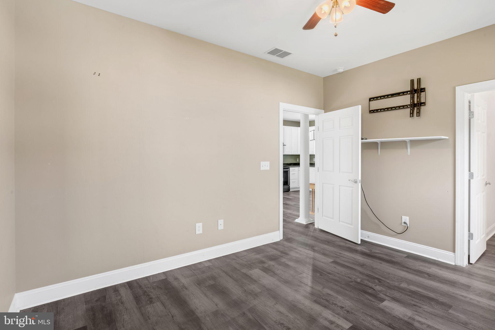 27407 Walking Run Milton, DE 19968 - Photo 16 of 25 an empty room with wooden floor and closet
