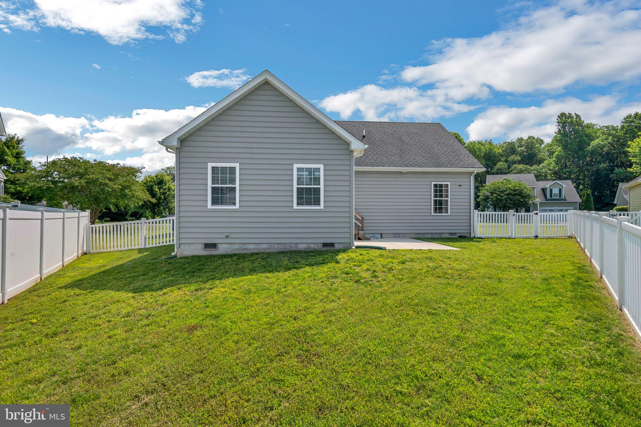 27407 Walking Run Milton, DE 19968 - Photo 25 of 25 a view of backyard of house with wooden deck and seating space
