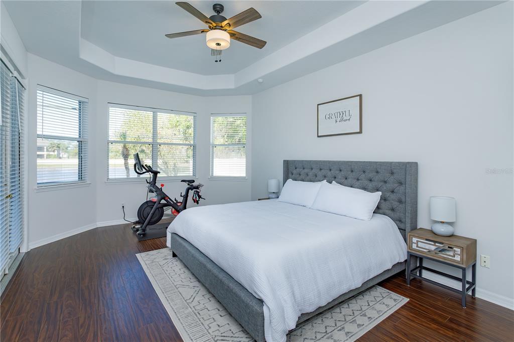 1572 St Regis Point Sanford, FL 32771 - Photo 16 of 30 a bedroom with a bed a chandelier and a window