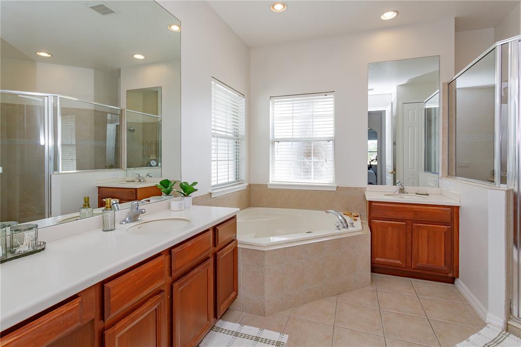 1572 St Regis Point Sanford, FL 32771 - Photo 18 of 30 a bathroom with a sink double vanity shower and bathtub