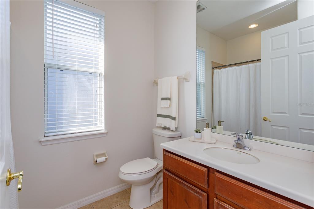 1572 St Regis Point Sanford, FL 32771 - Photo 19 of 30 a bathroom with a granite countertop sink toilet and mirror