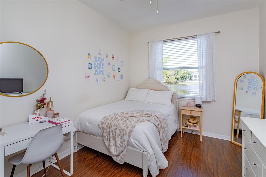 1572 St Regis Point Sanford, FL 32771 - Photo 20 of 30 a bedroom with a bed a dresser and a large window