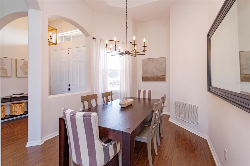 1572 St Regis Point Sanford, FL 32771 - Photo 5 of 30 a view of a dining room with furniture and wooden floor