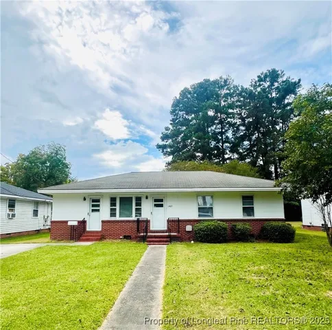 a front view of a house with yard porch and furniture