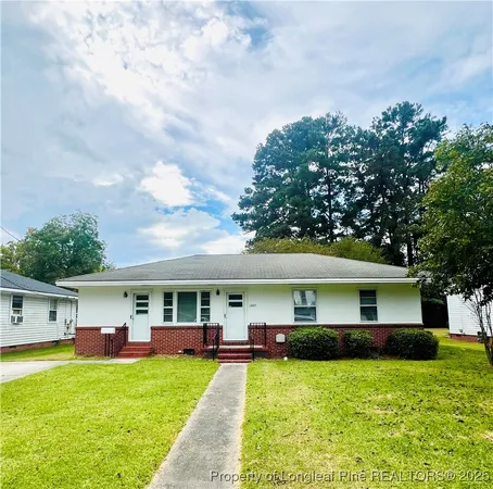 a front view of a house with a yard table and chairs