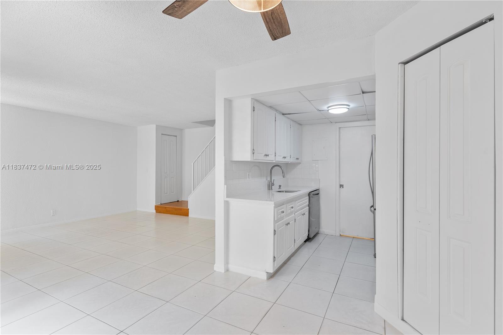 6603 Winfield Boulevard, Unit B2 Margate, FL 33063 - Photo 12 of 28 a large white kitchen with white cabinets and sink