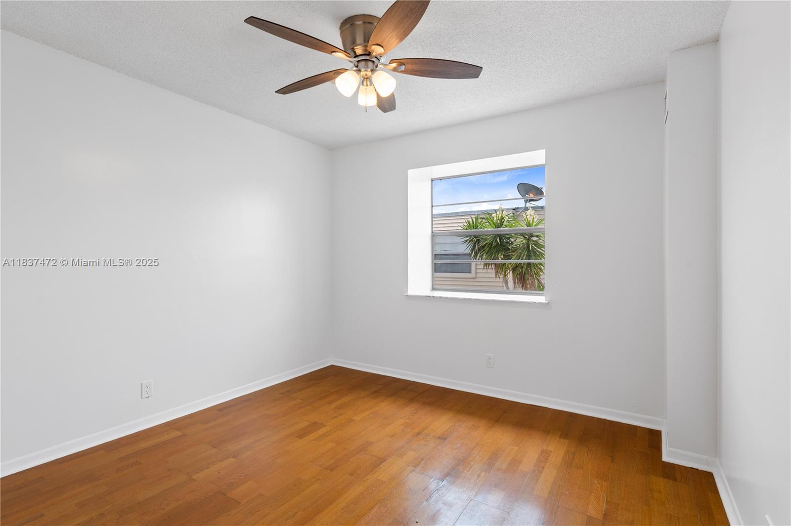 6603 Winfield Boulevard, Unit B2 Margate, FL 33063 - Photo 18 of 28 an empty room with a window and a fan