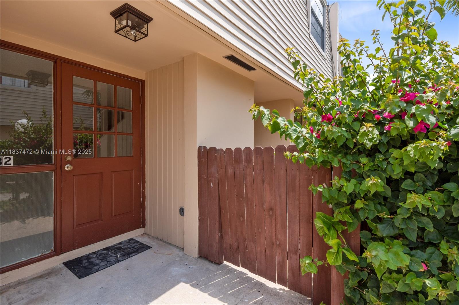 6603 Winfield Boulevard, Unit B2 Margate, FL 33063 - Photo 2 of 28 a flower plants in front of door