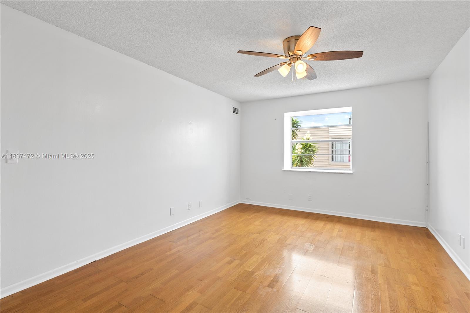 6603 Winfield Boulevard, Unit B2 Margate, FL 33063 - Photo 21 of 28 an empty room with a window and a fan