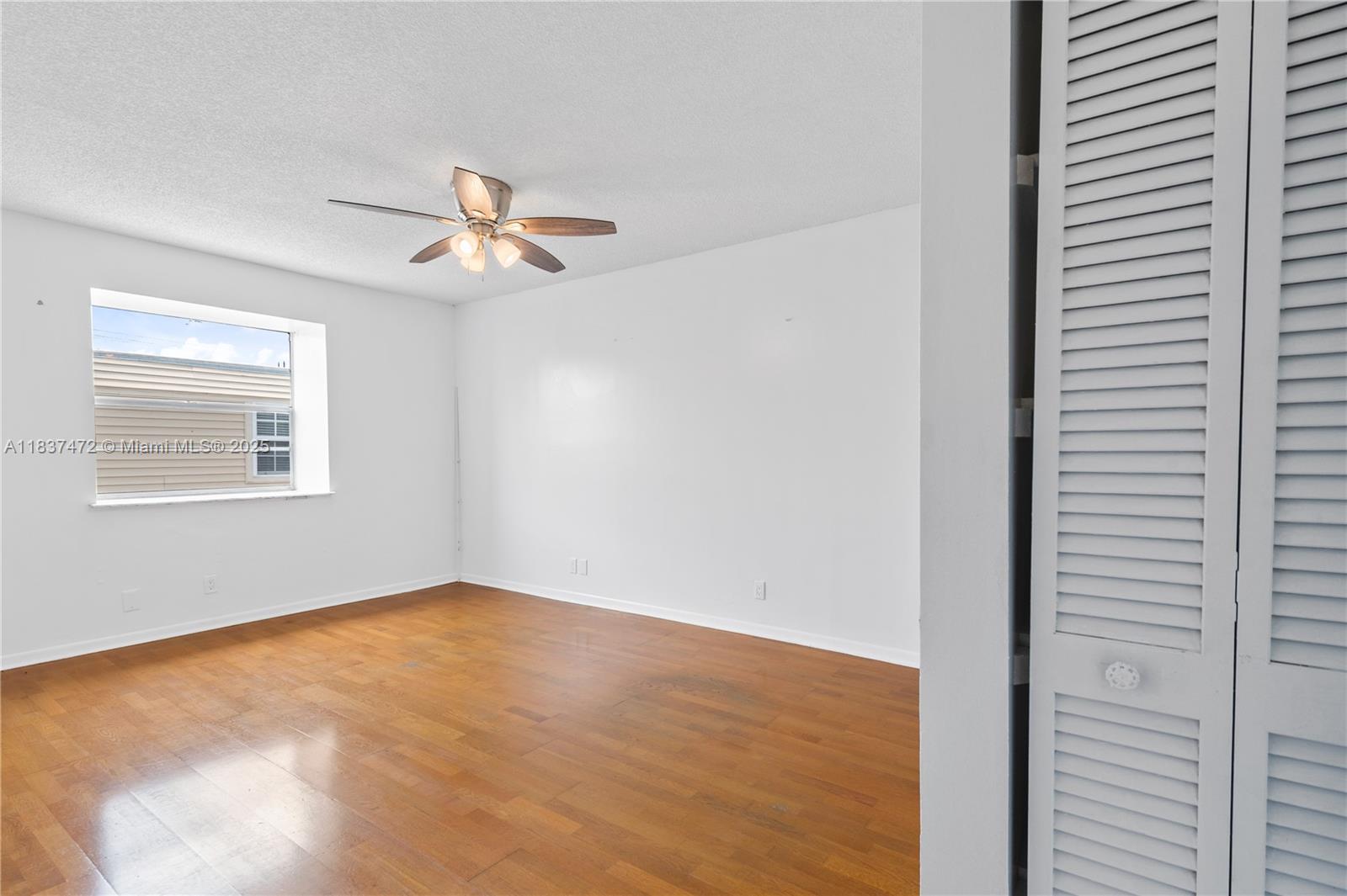 6603 Winfield Boulevard, Unit B2 Margate, FL 33063 - Photo 22 of 28 a view of a room with wooden floor and a ceiling fan