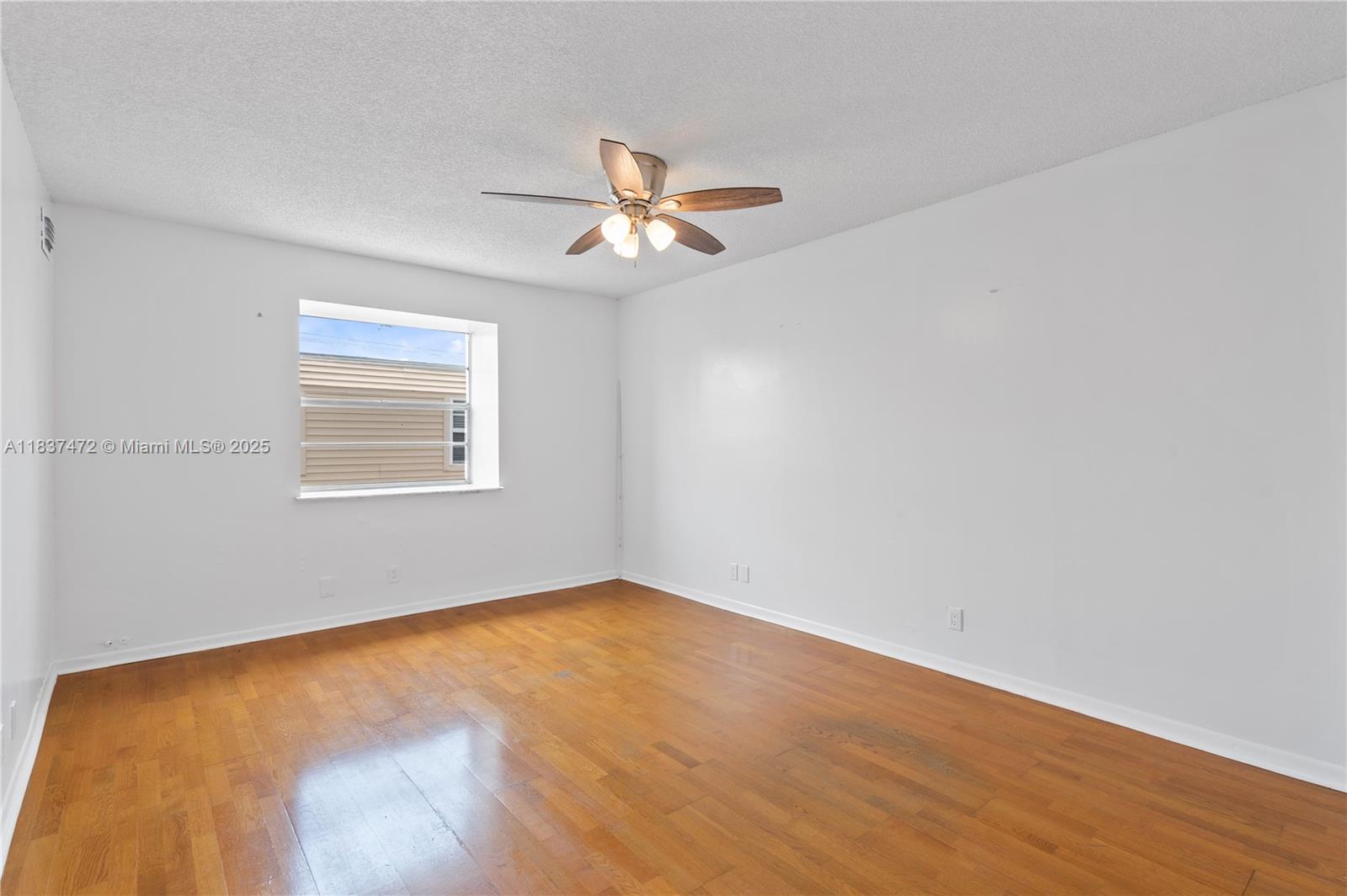 6603 Winfield Boulevard, Unit B2 Margate, FL 33063 - Photo 23 of 28 an empty room with a window and ceiling fan