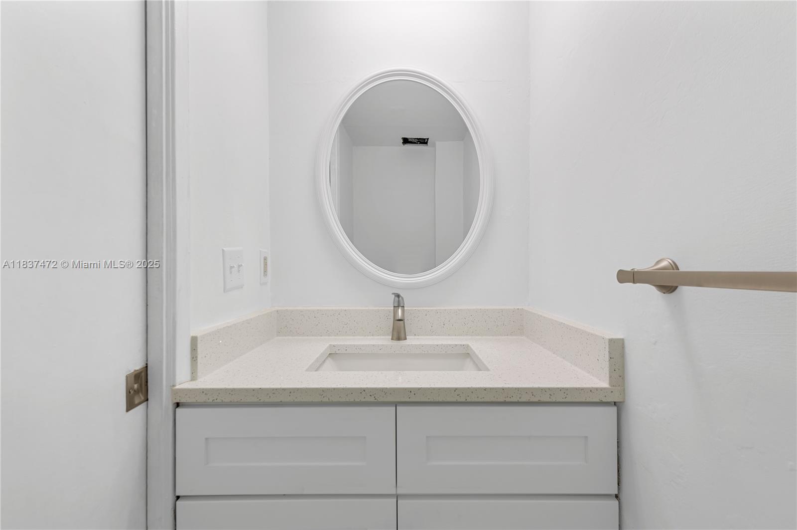 6603 Winfield Boulevard, Unit B2 Margate, FL 33063 - Photo 7 of 28 a bathroom with a sink and a mirror