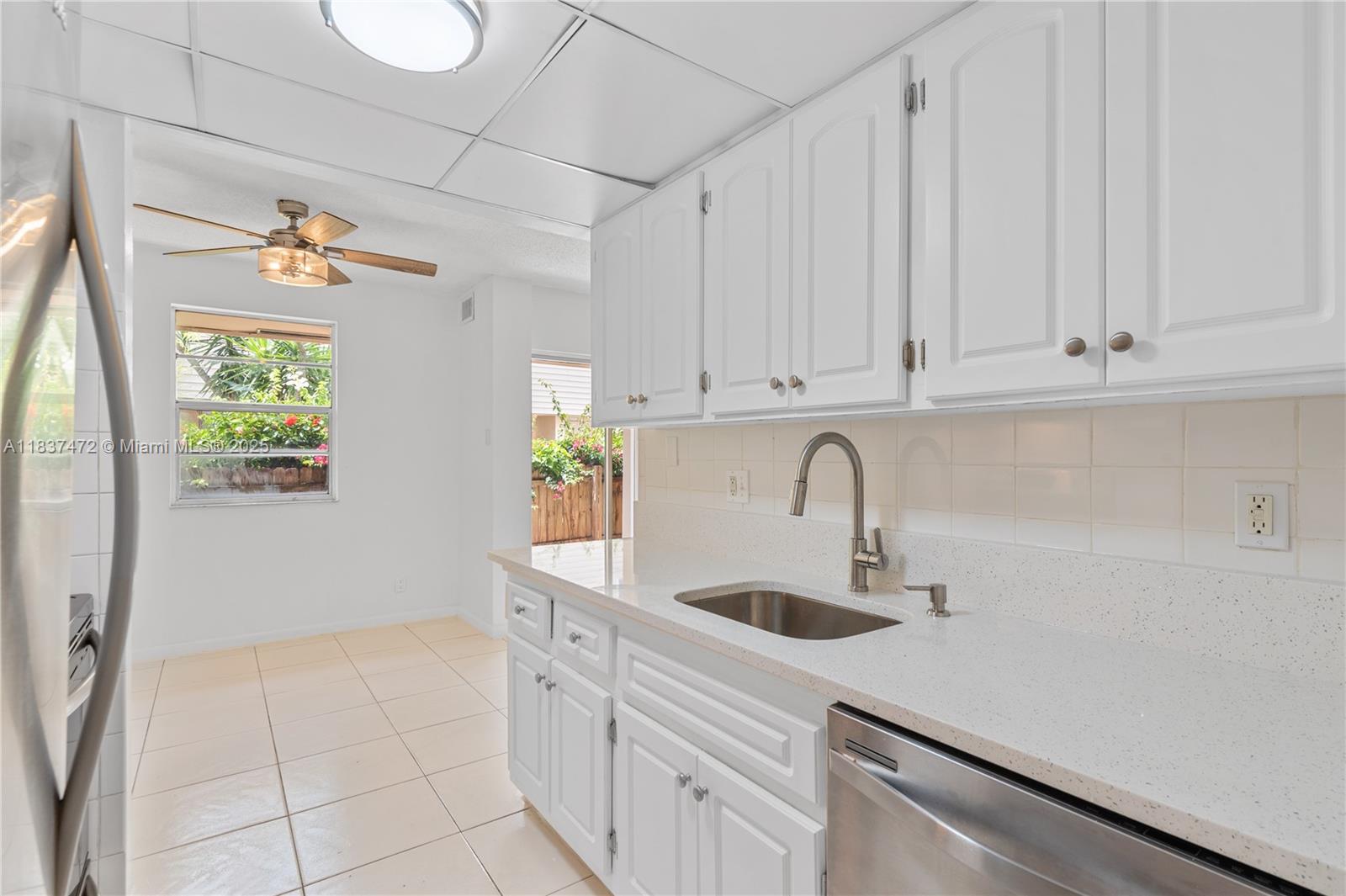 6603 Winfield Boulevard, Unit B2 Margate, FL 33063 - Photo 9 of 28 a kitchen with a sink and cabinets