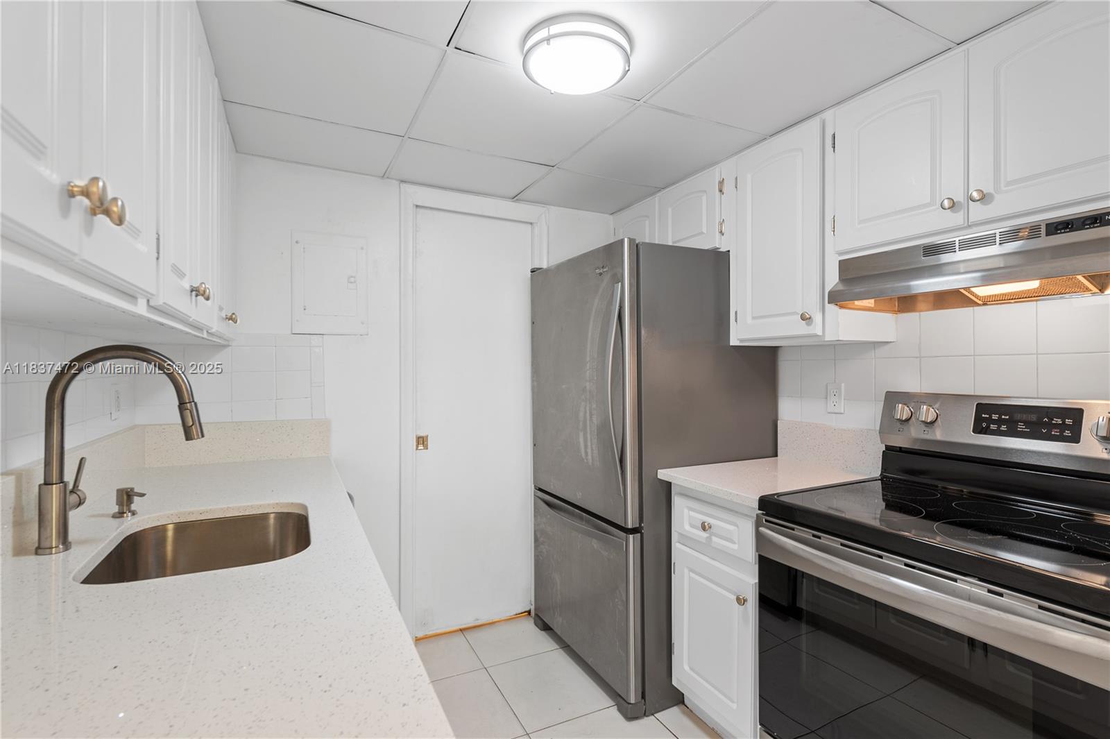 6603 Winfield Boulevard, Unit B2 Margate, FL 33063 - Photo 10 of 28 a kitchen with stainless steel appliances a refrigerator sink and cabinets