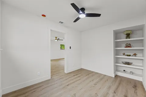a view of an empty room and wooden floor