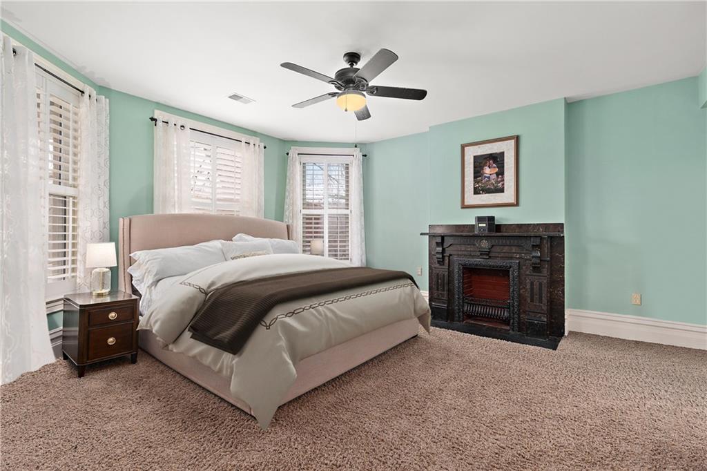 1000 River Road Beaver, PA 15009 - Photo 12 of 25 a spacious bedroom with a bed and a fireplace