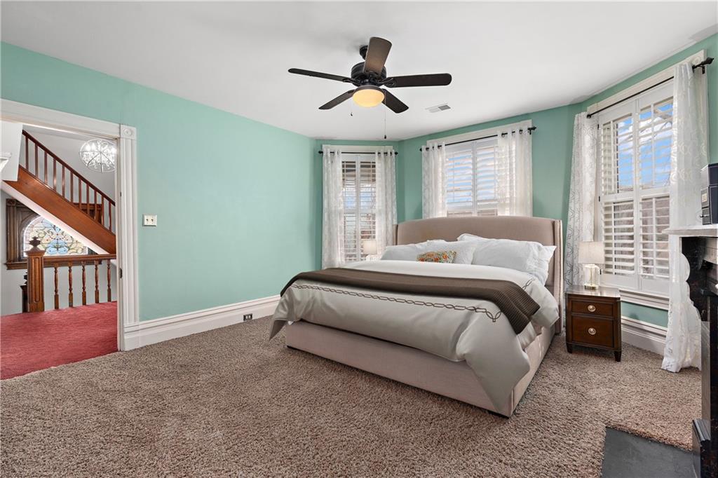 1000 River Road Beaver, PA 15009 - Photo 13 of 25 a bedroom with a large bed chandelier and a window