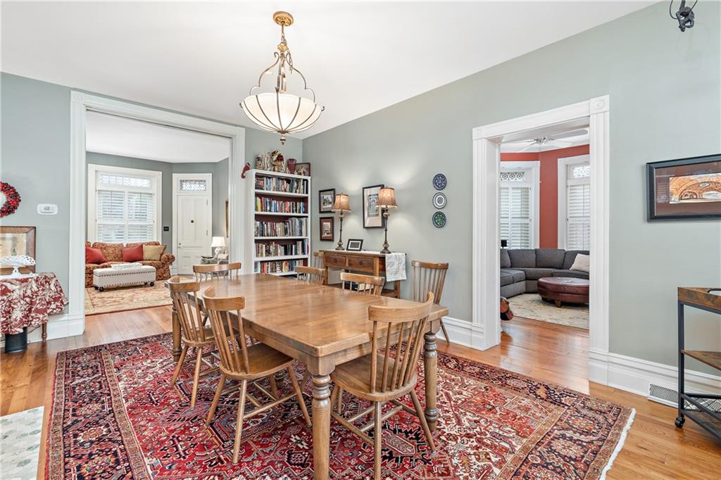 1000 River Road Beaver, PA 15009 - Photo 9 of 25 a view of a dining room and livingroom with furniture wooden floor a rug and a chandelier