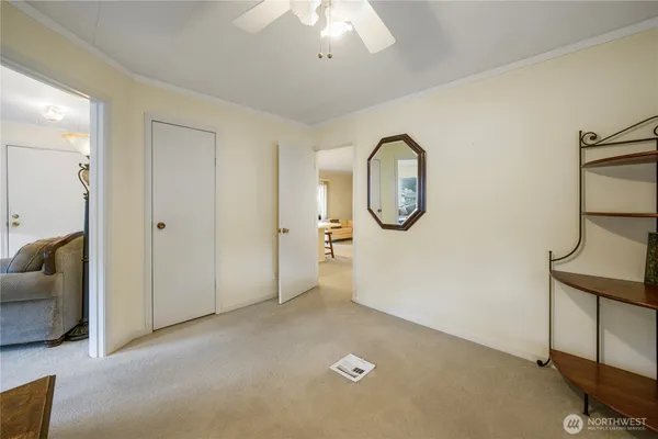 an empty room with windows and cabinet