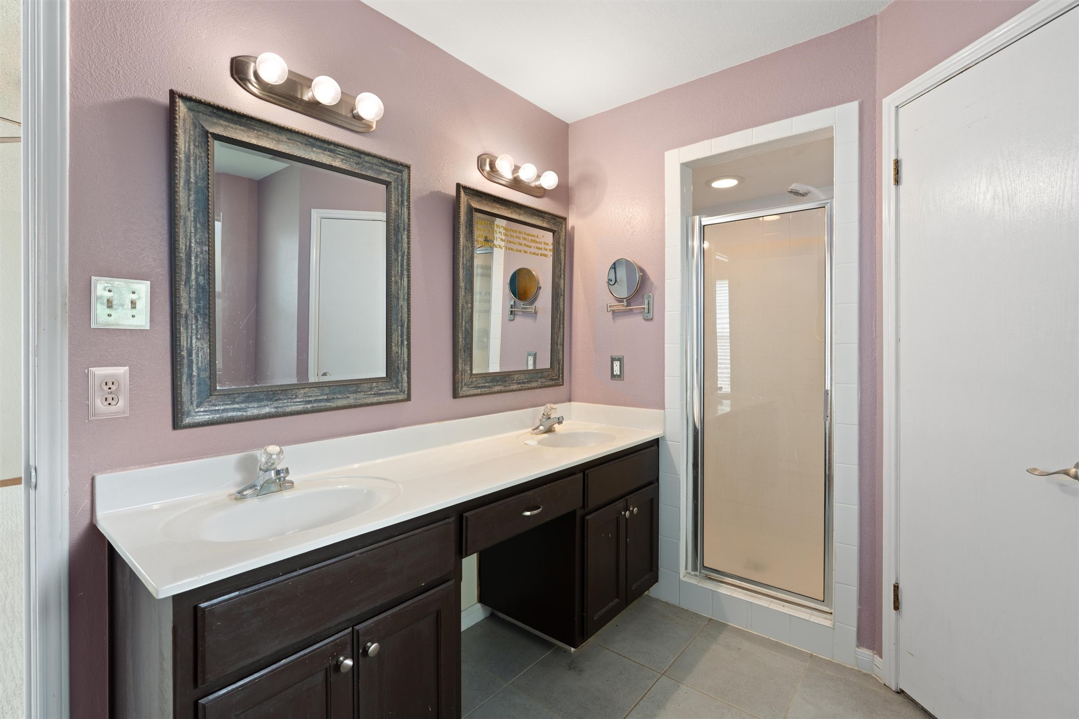 2306 Raintree Path Round Rock, TX 78664 - Photo 16 of 23 Double vanity and a walk-in shower elevate this practical bathroom space.