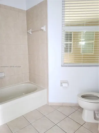 a aerial view of a house next to a yard