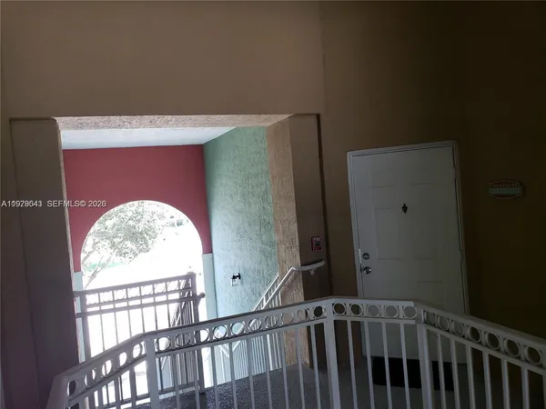 a view of staircase with rug