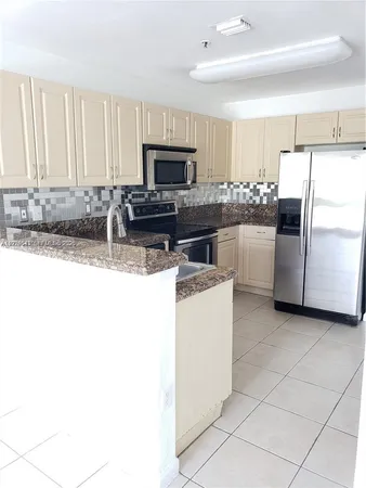 a kitchen with a refrigerator sink and microwave