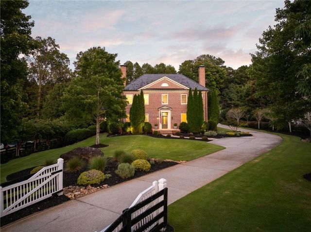 a front view of a house with a yard table and chairs