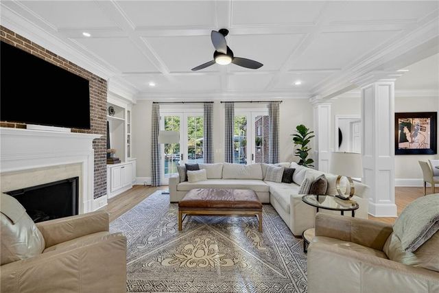 a living room with furniture fireplace and flat screen tv