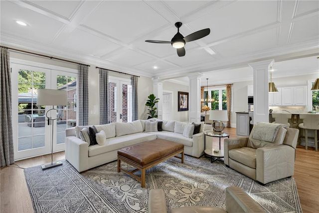 a kitchen with stainless steel appliances granite countertop a kitchen island a stove a table and chairs in it