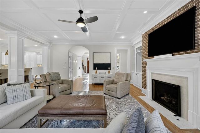 a kitchen that has a lot of cabinets a sink and a wooden floor