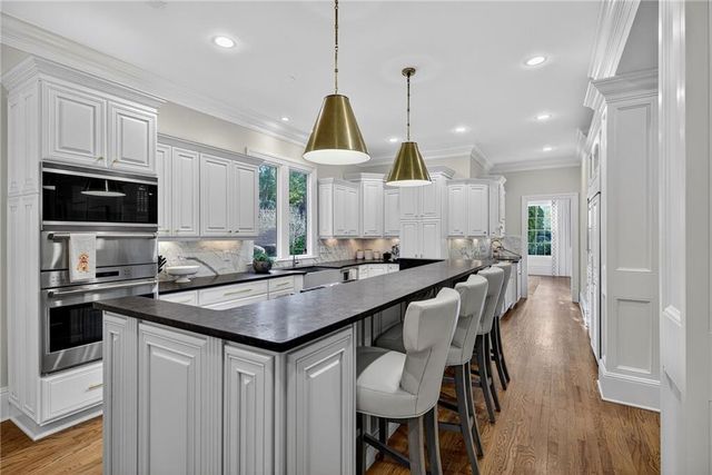 a kitchen with stainless steel appliances granite countertop a stove and a sink