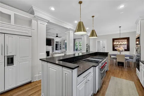 a view of a dining room with furniture wooden floor and chandelier
