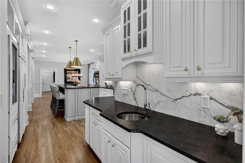 a spacious bathroom with a granite countertop sink mirror and shower