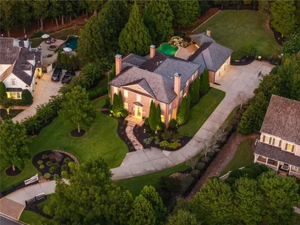 an aerial view of a house with garden space and street view