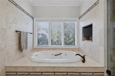 a view of a hallway with couches and dining table chairs