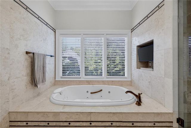 a view of a hallway with couches and dining table chairs