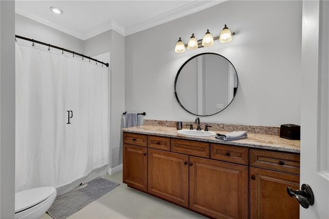 a kitchen with stainless steel appliances granite countertop a sink and wooden cabinets