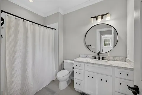 a view of room with flat screen tv and hallway