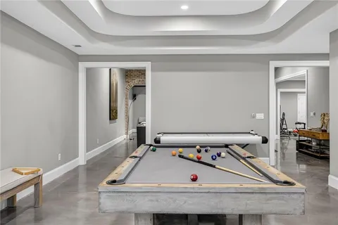 an aerial view of a house with a swimming pool patio and outdoor seating