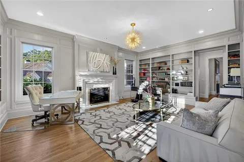 a dining room with furniture a chandelier and wooden floor