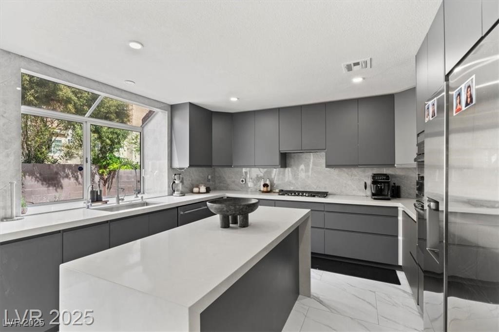 9416 Rolling Ridge Lane Las Vegas, NV 89134 - Photo 12 of 34 Kitchen with modern cabinets, gray cabinets, a center island, light marble finish flooring, and recessed lighting